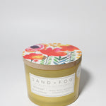 Midnight Blue Citrus 12 oz scented candle Yellow vessel with Painted Flower garden lid