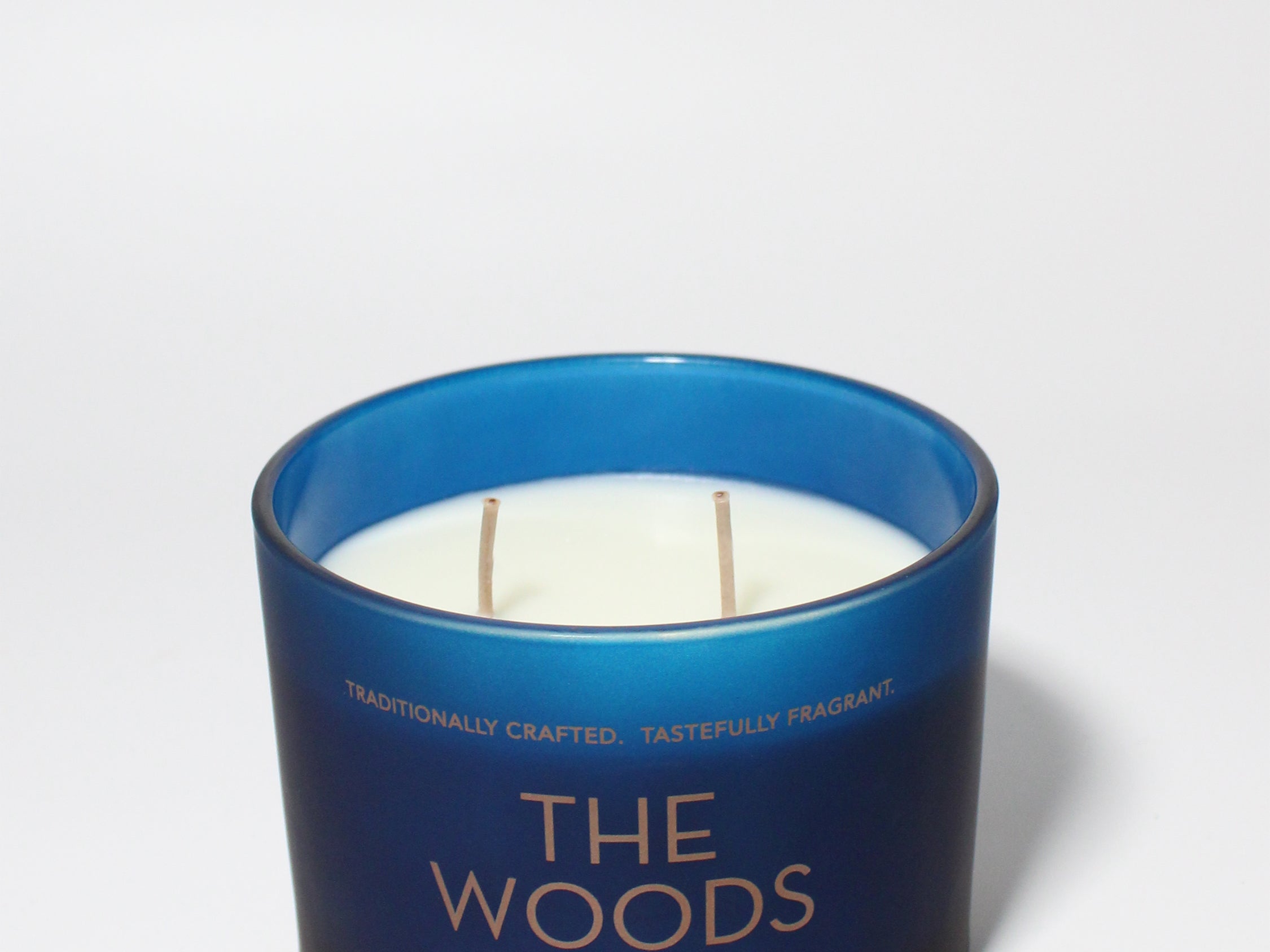 The Woods 12 oz scented candle Navy vessel with Copper lid