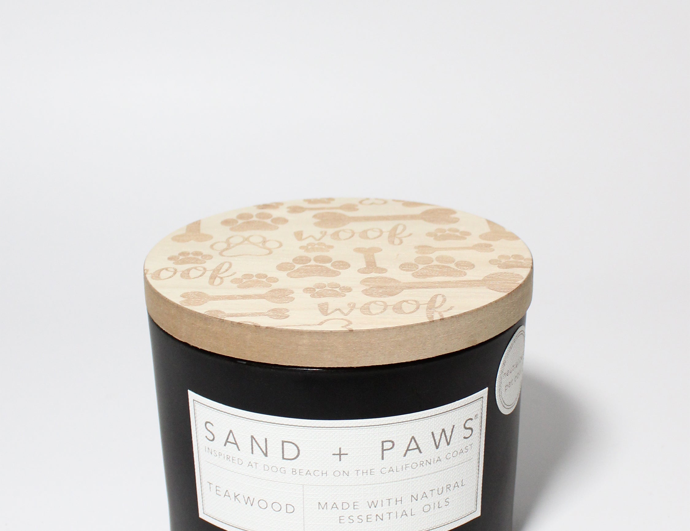 Sand + Paws Teakwood 12 oz scented candle Black vessel with Carved Bones & Woof lid