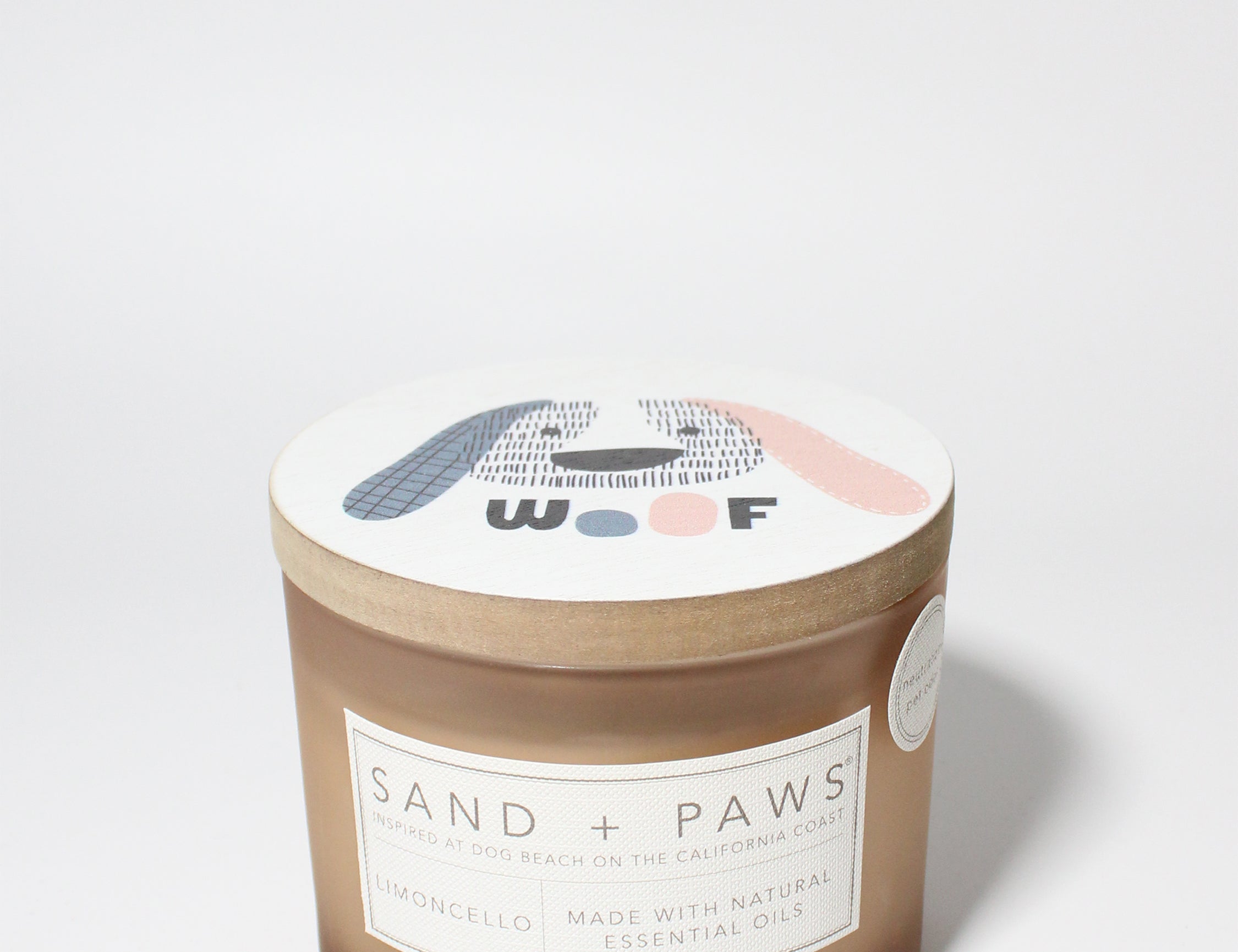Sand + Paws Limoncello 12 oz scented candle Soft Pink vessel with WOOF dog face lid