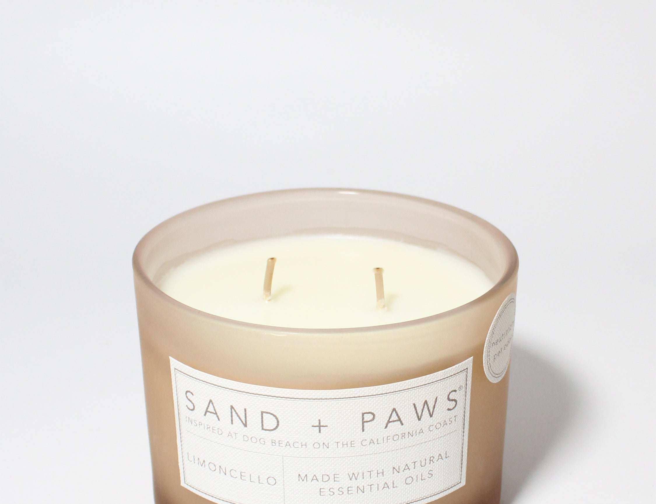 Sand + Paws Limoncello 12 oz scented candle Soft Pink vessel with WOOF dog face lid