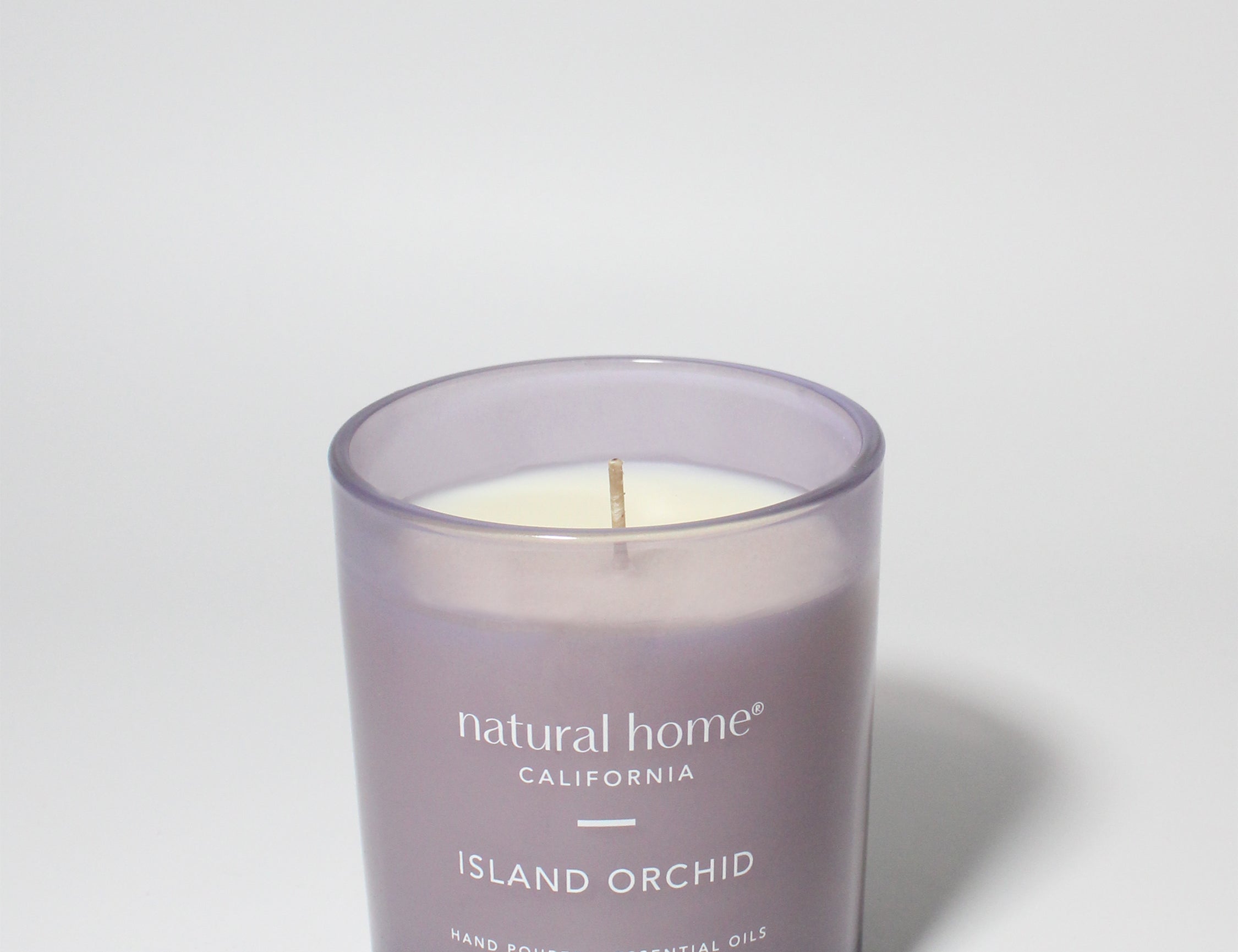 Island Orchid Natural Home 11.5 oz scented candle Purple vessel with solid metal lid