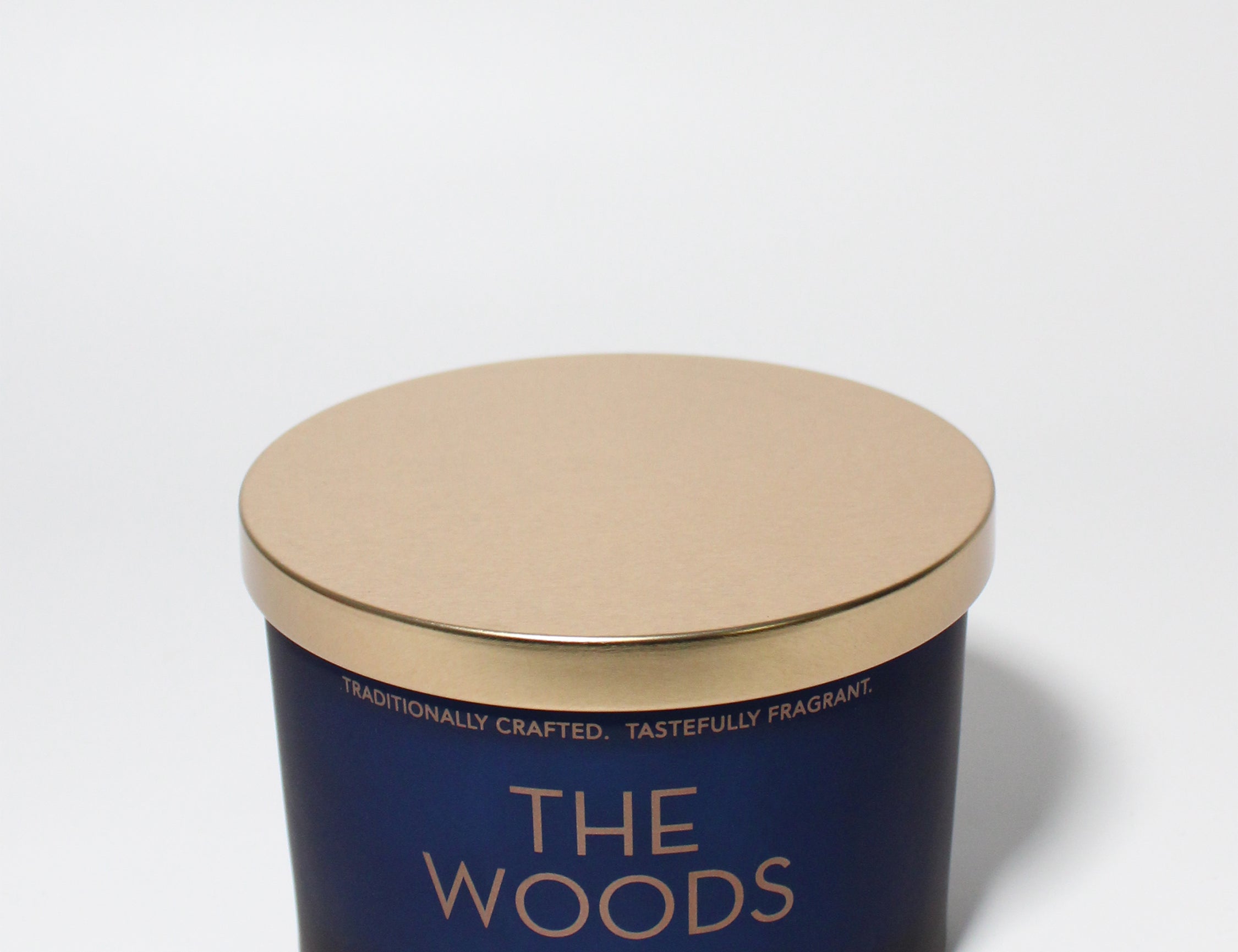 The Woods 12 oz scented candle Navy vessel with Copper lid