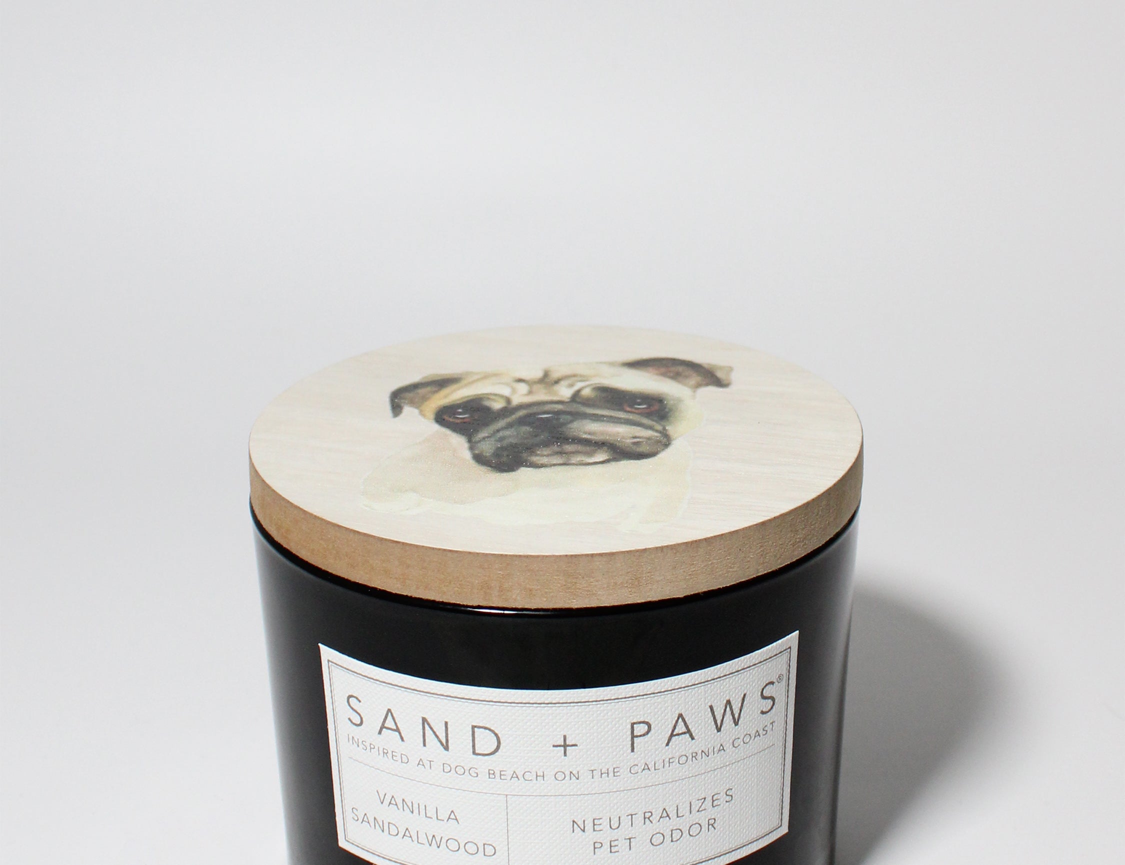 Sand + Paws Vanilla Sandalwood 12 oz scented candle Black vessel with Painted Pug Lid