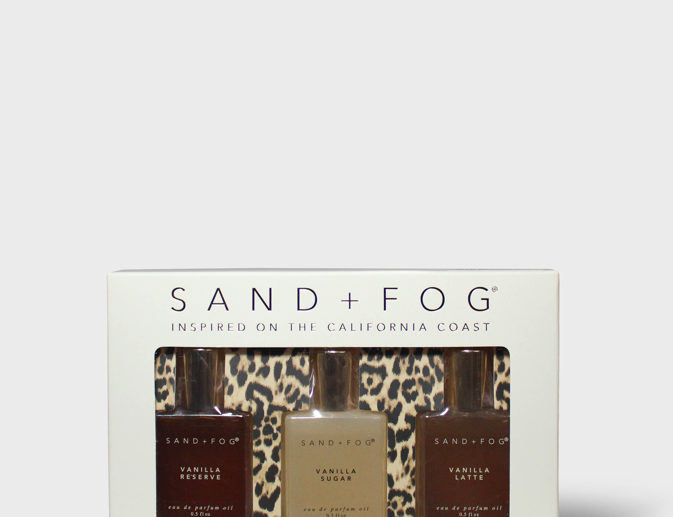 SAND+FOG perfume oil discovery set box with rollerball bottles and leopard print labels