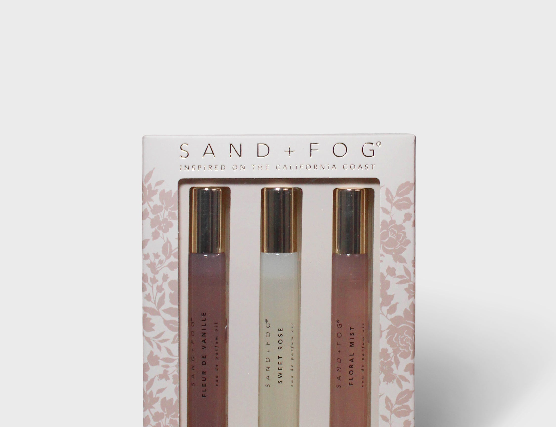 Floral perfume oil set with three amber roller bottles in a gift box