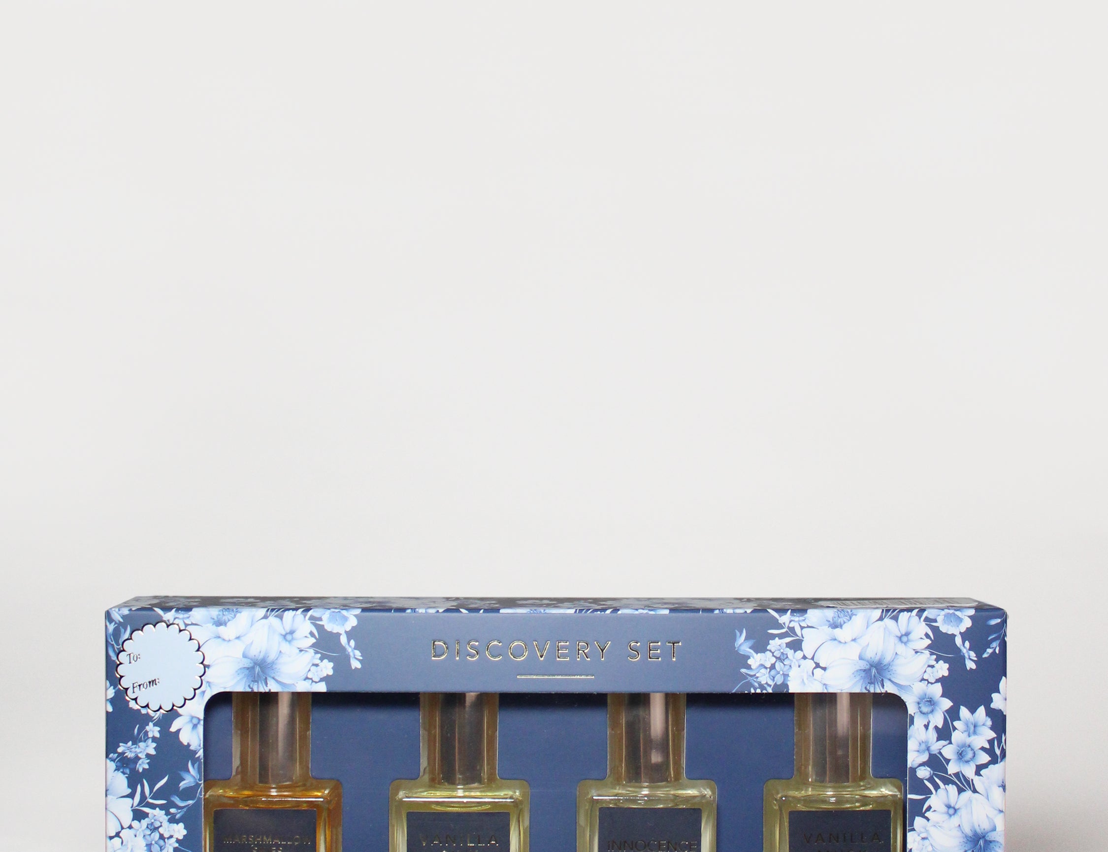 Perfume oil rollerball discovery set in blue floral box with four glass bottles