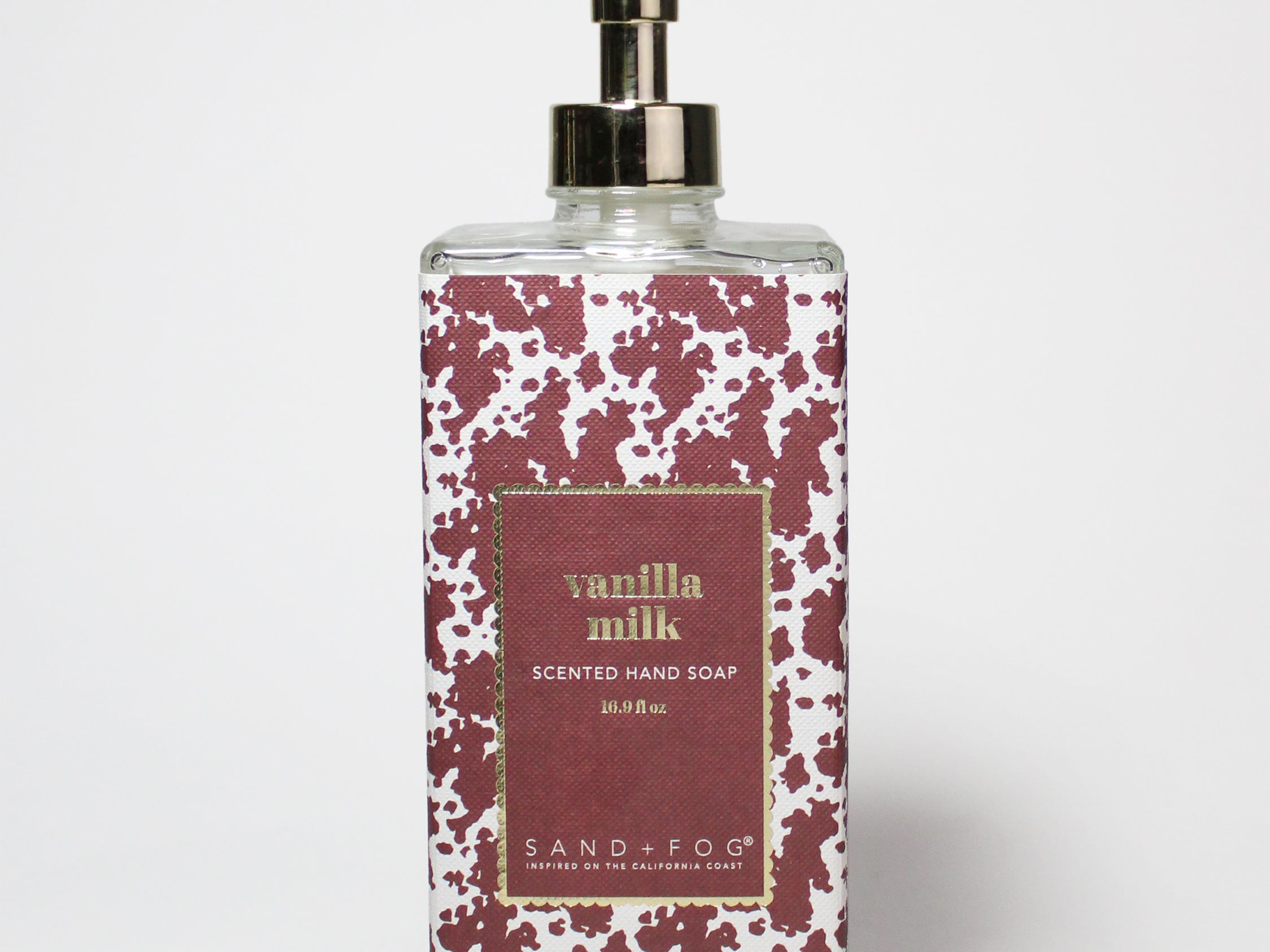 Clear liquid hand soap bottle with gold pump, maroon speckled vanilla milk label