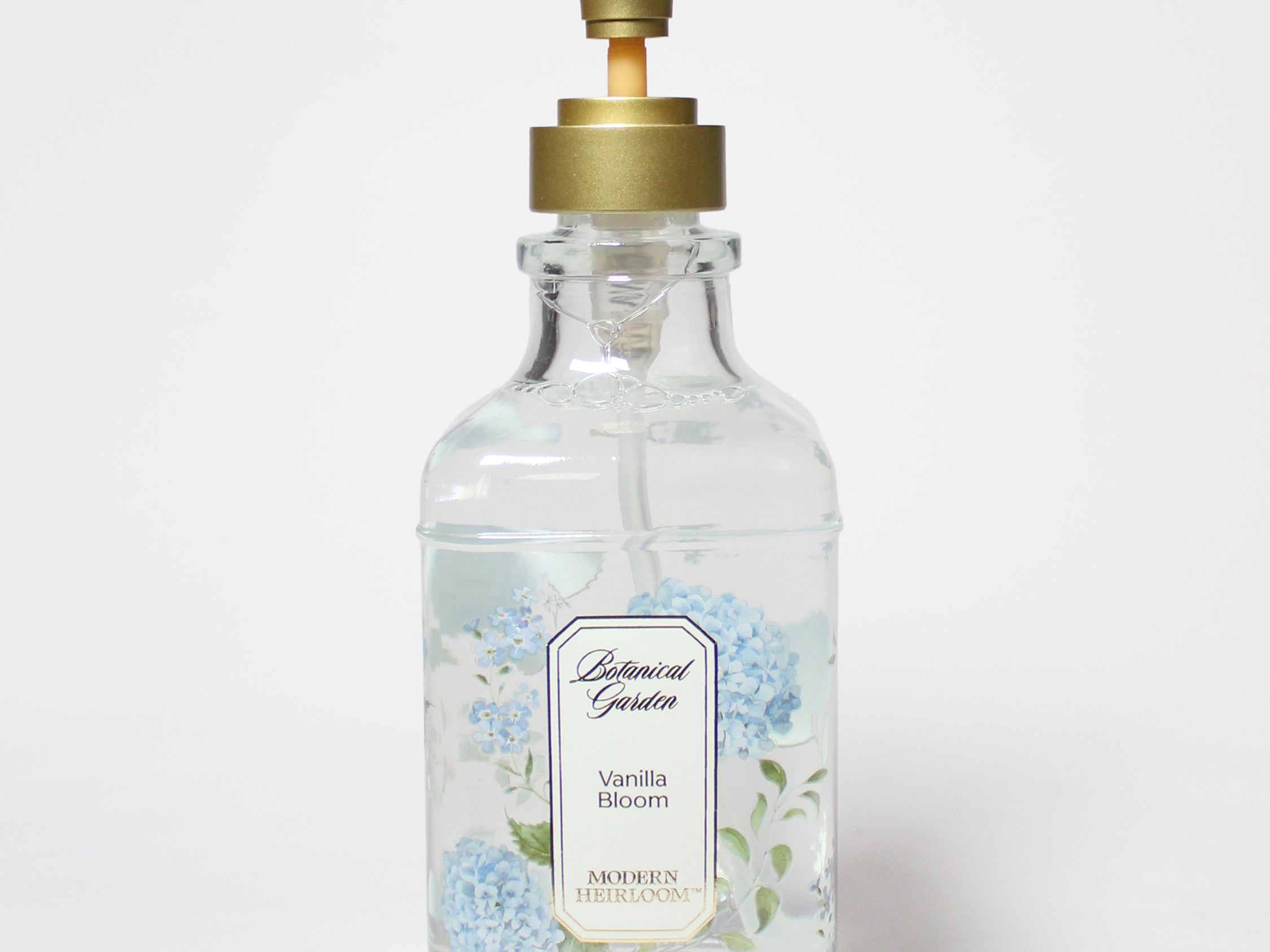 Liquid hand soap with clear bottle, gold pump, blue floral Vanilla Bloom label