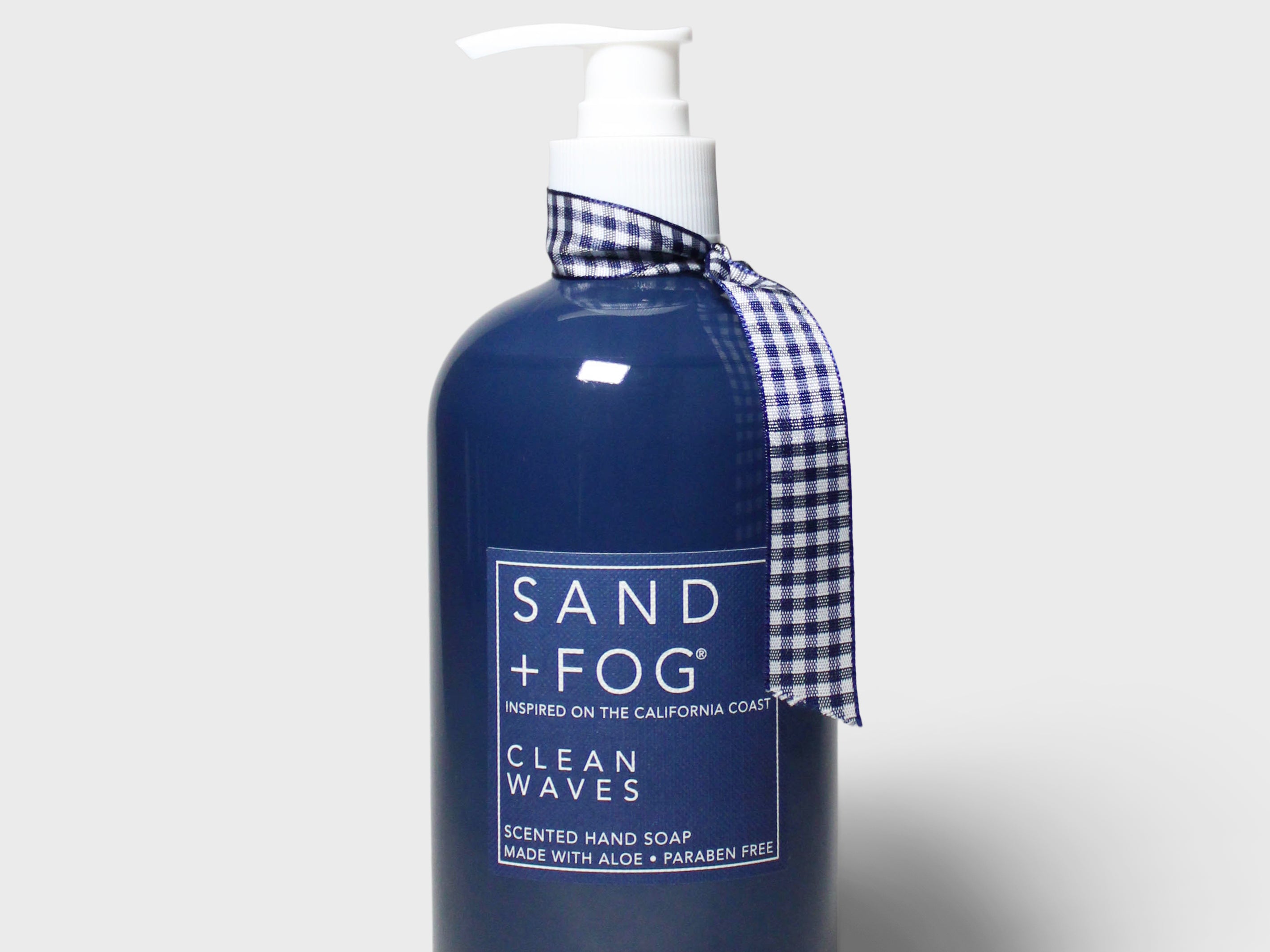 Navy liquid hand soap bottle with white pump and blue plaid ribbon label