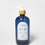 Dark blue liquid hand soap bottle with gold pump and Ocean Mist label