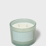 12 oz scented candle in frosted green jar with two wicks and visible wax