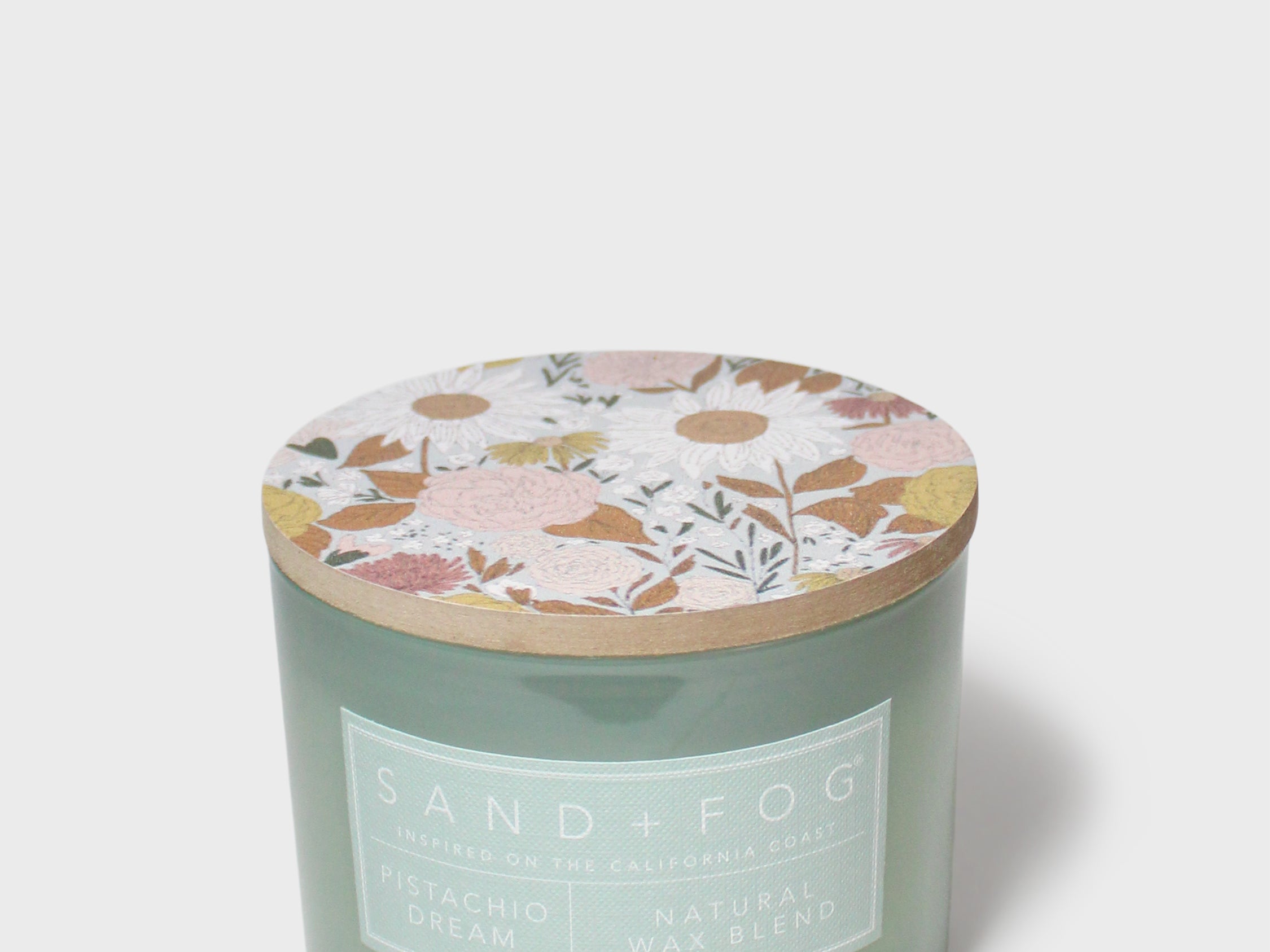 Pistachio Dream 12 oz scented candle in frosted green glass with floral lid
