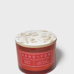 SAND + FOG Sweet Apple scented candle in red glass jar with patterned lid