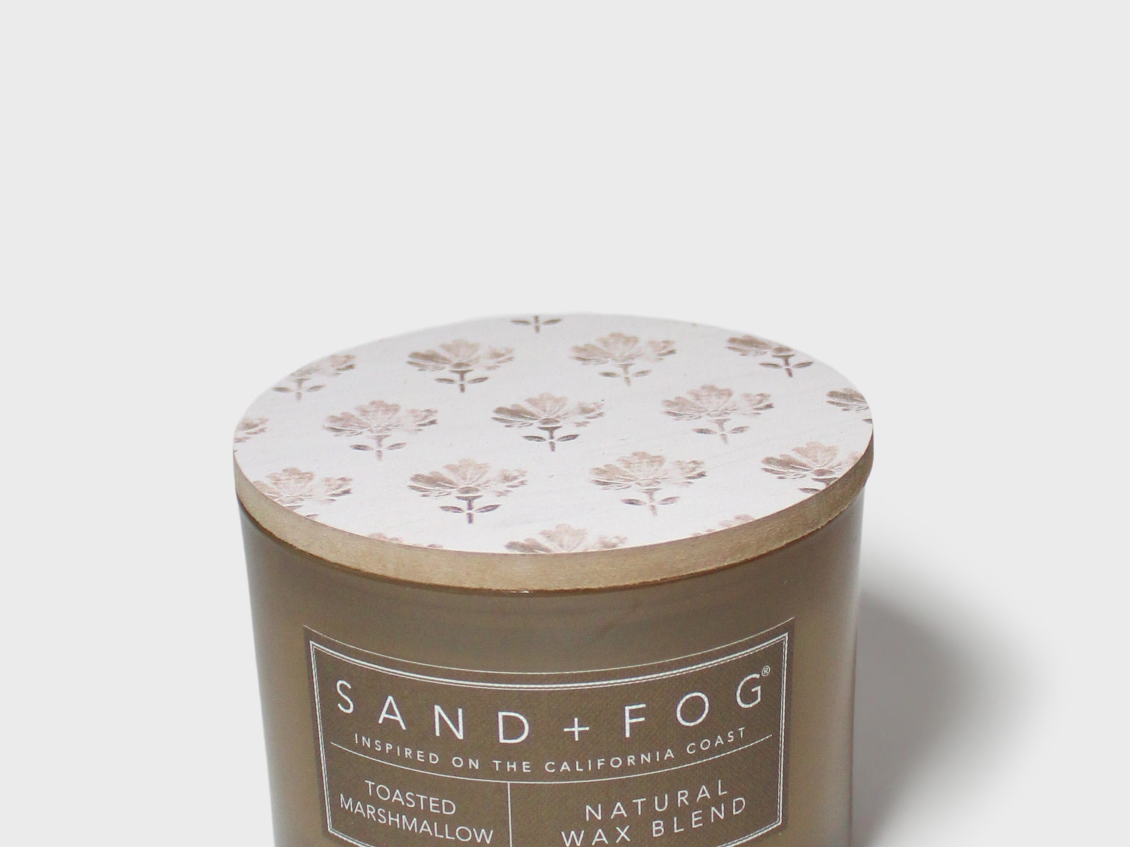 SAND + FOG scented candle in dark brown glass jar with floral lid