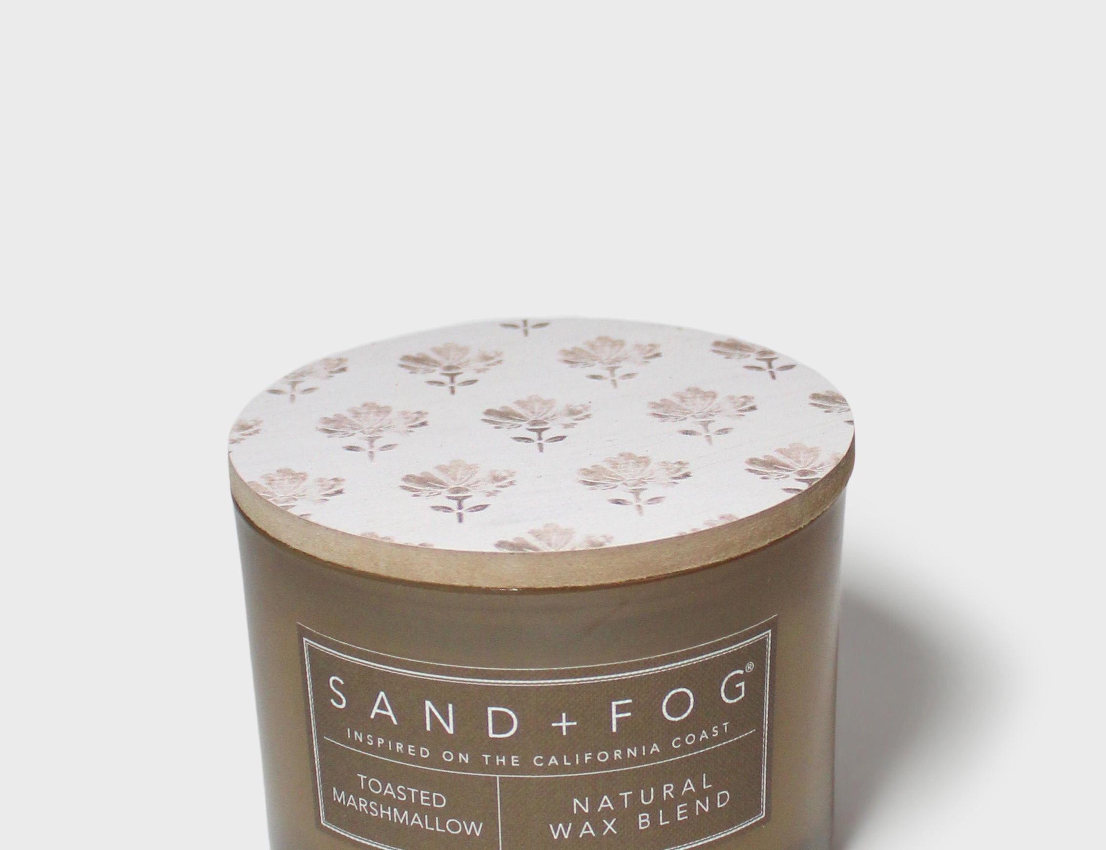 SAND + FOG scented candle in dark brown glass jar with floral lid