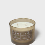 SAND + FOG scented candle in dark brown glass jar with two wicks, natural wax blend