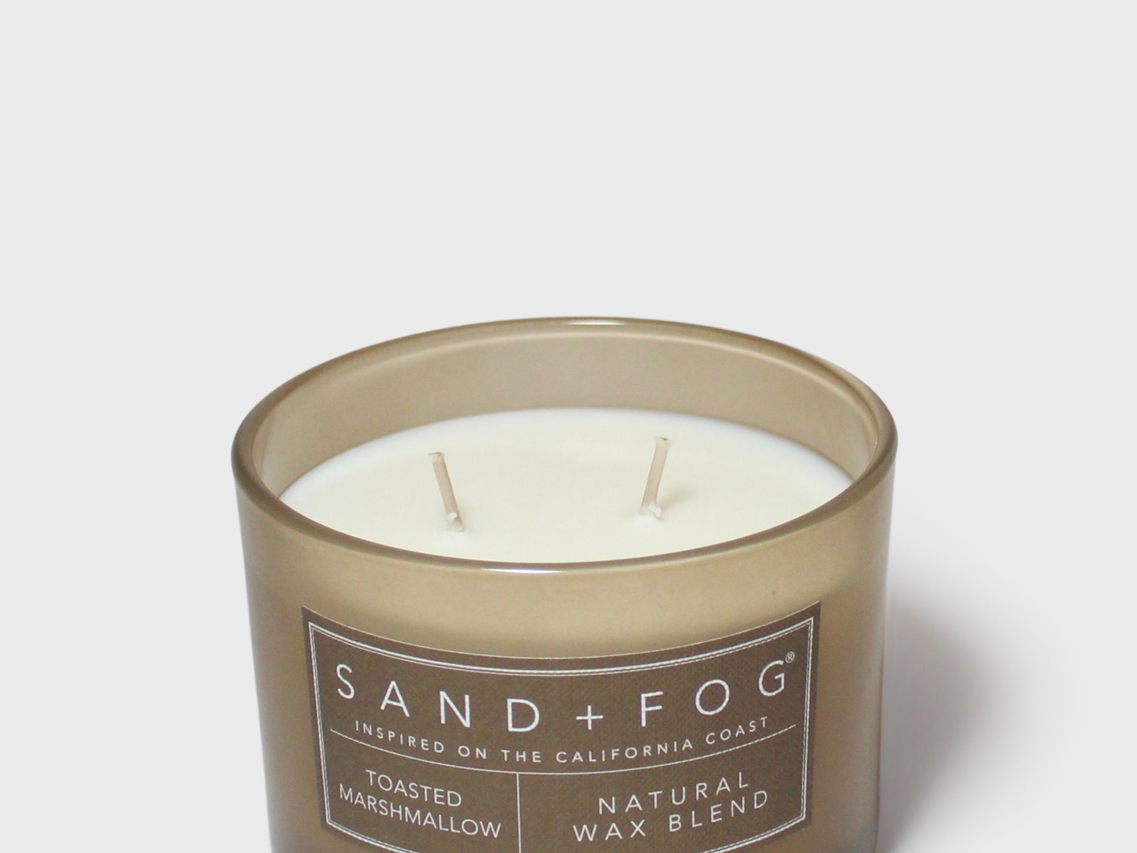 SAND + FOG scented candle in dark brown glass jar with two wicks, natural wax blend