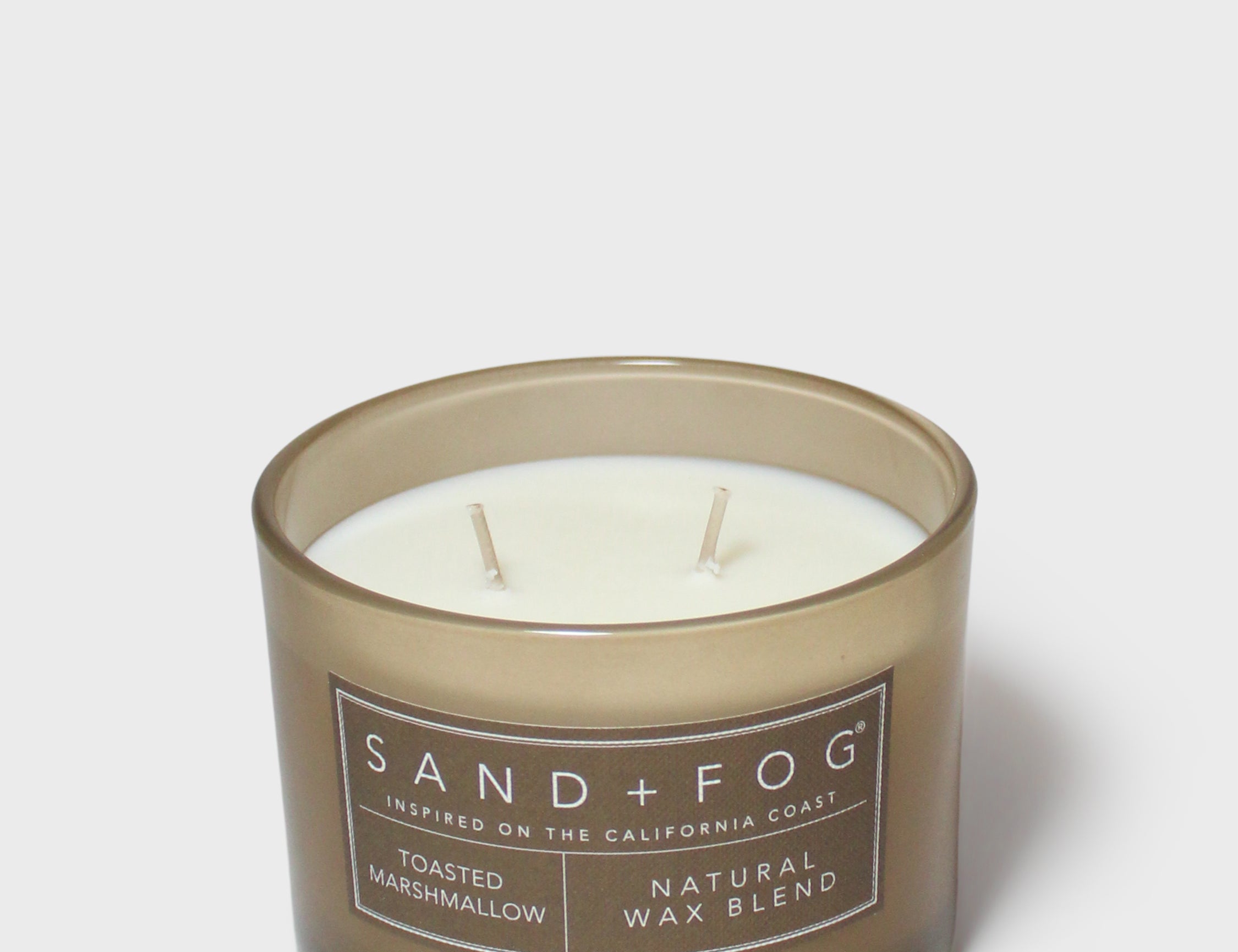 SAND + FOG scented candle in dark brown glass jar with two wicks, natural wax blend