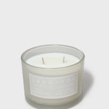 Scented jar candle with white wax and two wicks, gray glass, Sand + Fog label