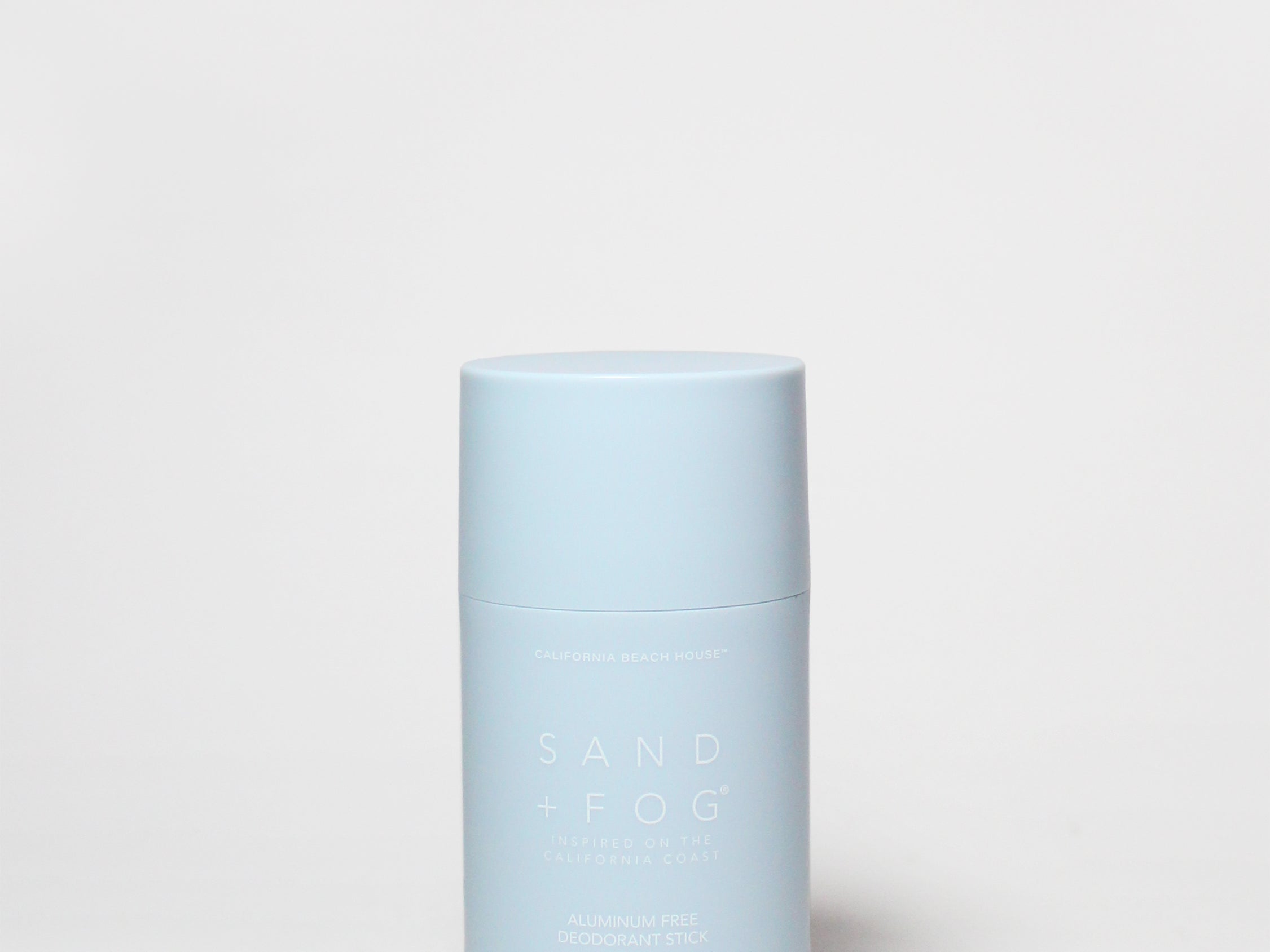 Pale blue deodorant container with white cap and vertical label