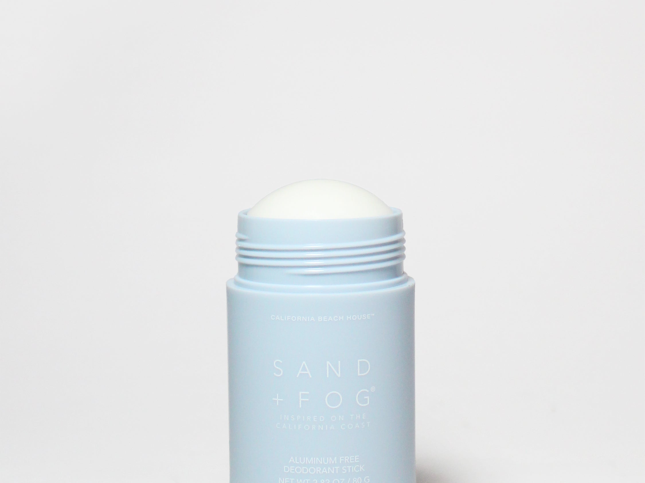 Pale blue deodorant container with white screw-on cap