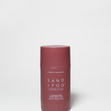 Burgundy deodorant stick with flat red cap, Sand + Fog label, 2.89 oz
