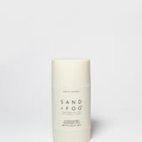 Vanilla coconut deodorant stick, off-white cylinder with Sand + Fog label