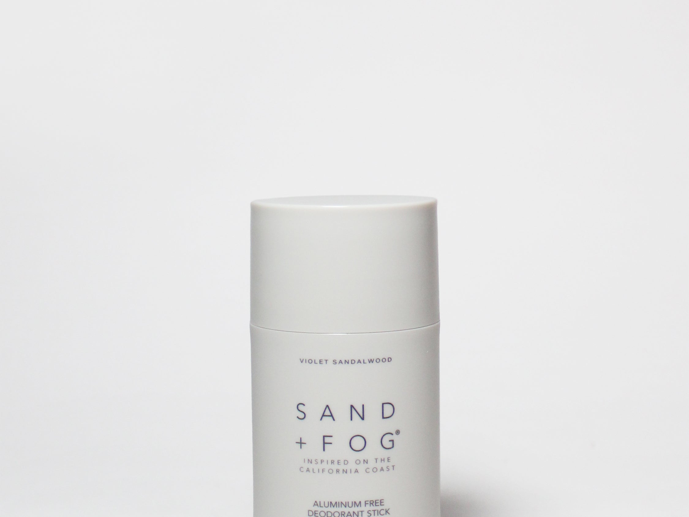 SAND + FOG deodorant stick, white tube with violet sandalwood label