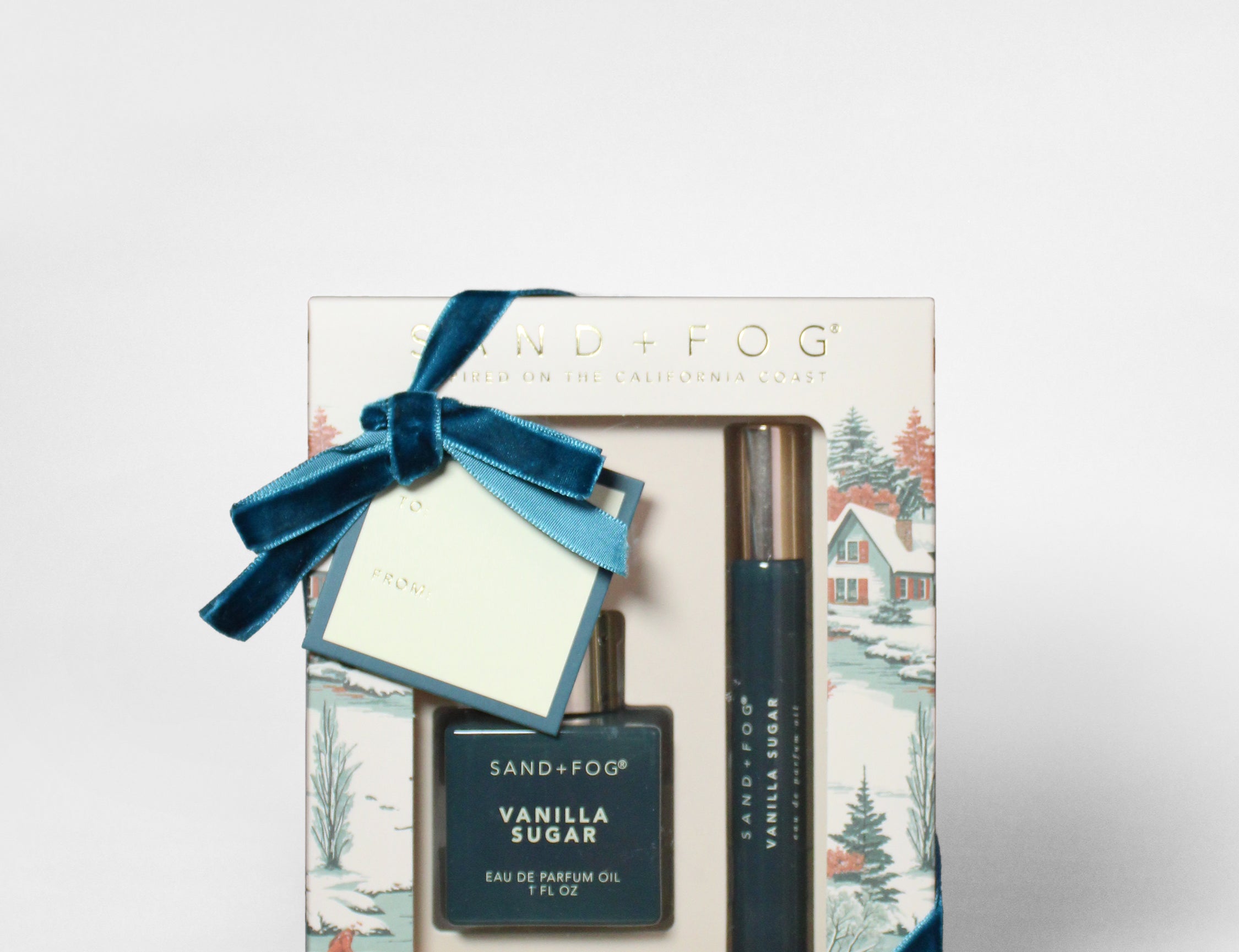 Perfume oil rollerball set in gift box with blue ribbon and dark bottle