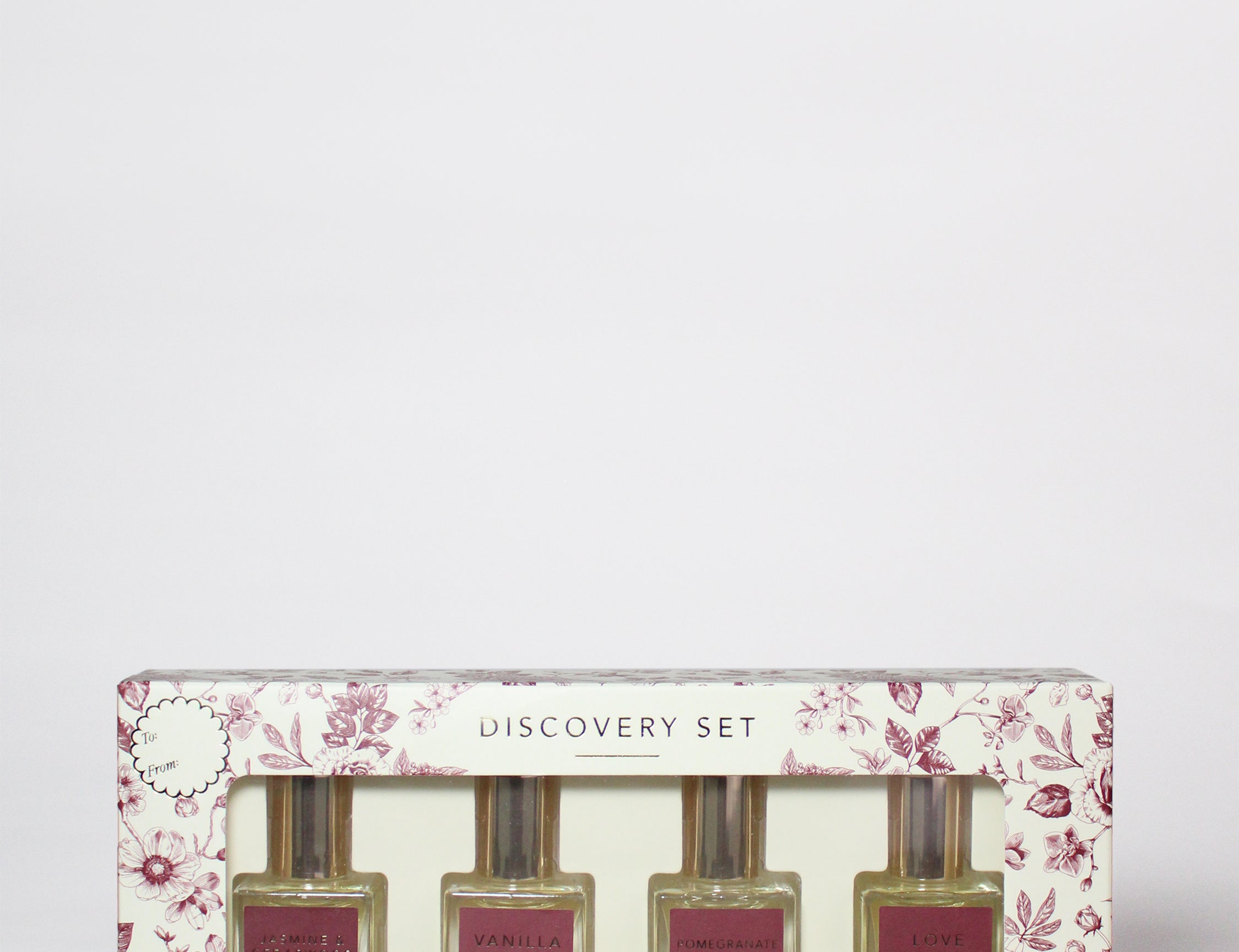Perfume oil rollerball discovery set box with Sand+Fog bottles and cranberry labels