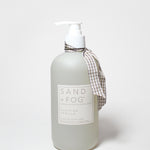 Matte white liquid hand soap bottle with white pump; beige plaid bow and label
