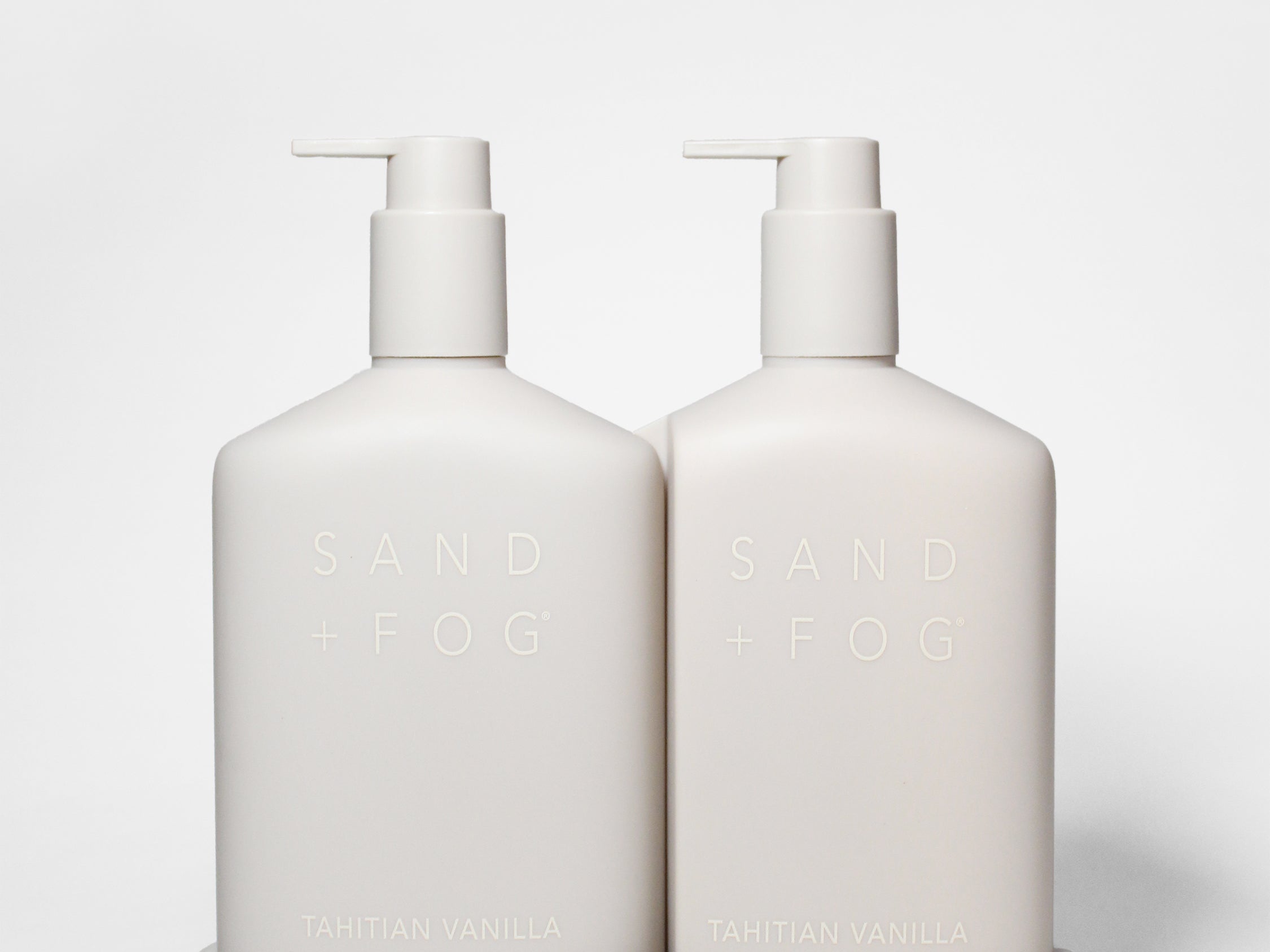 Tahitian Vanilla hand soap and lotion set in two white pump bottles with a matching tray