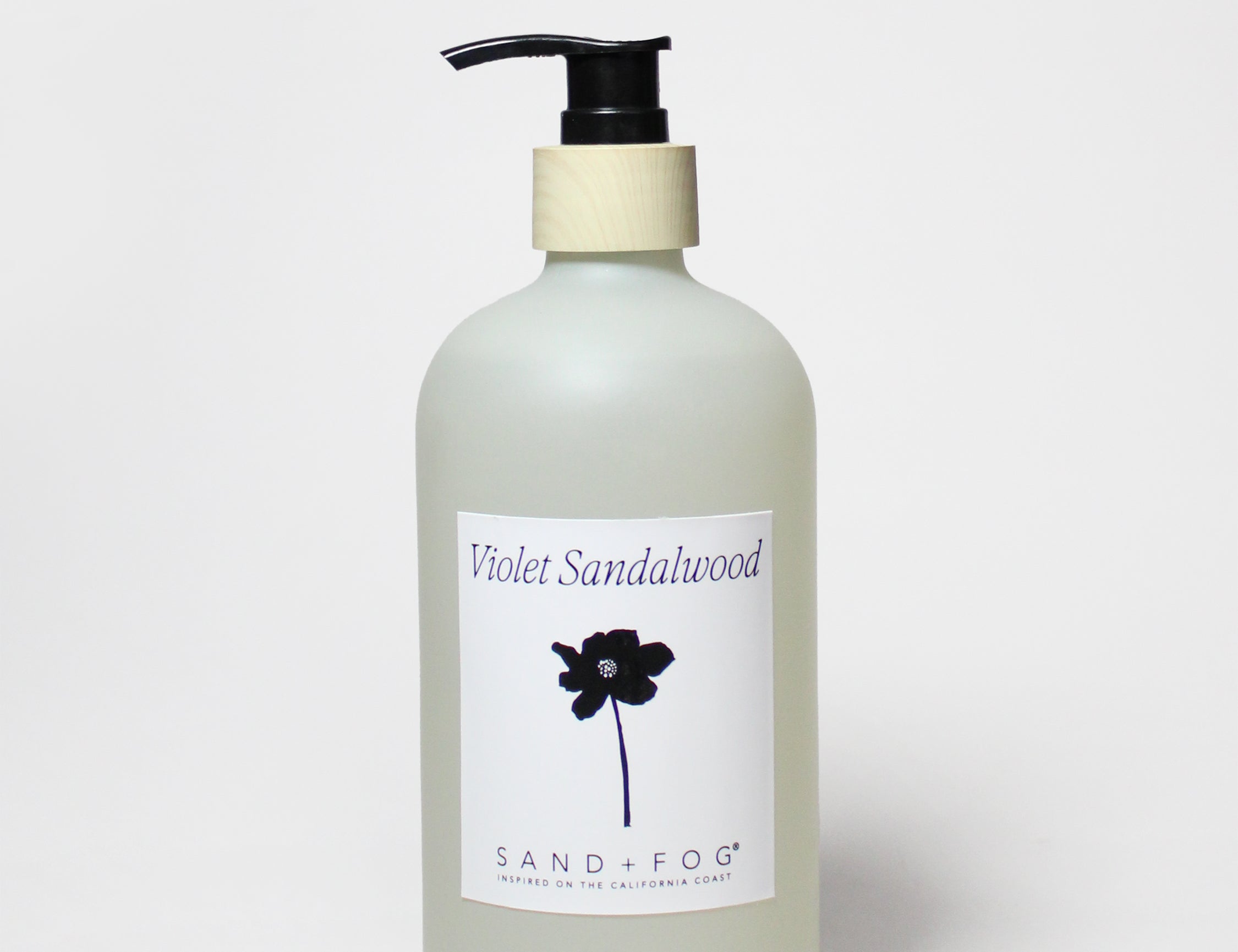 Liquid hand soap bottle with violet sandalwood label and black pump