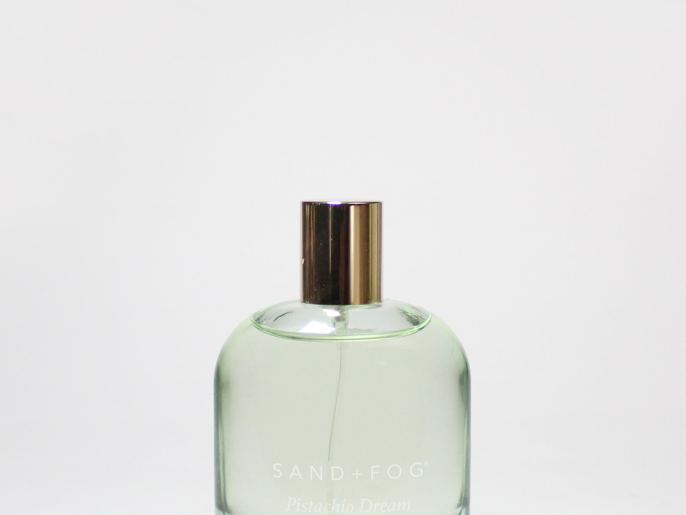 Light green glass body oil perfume bottle with gold cap