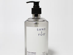 Liquid hand soap bottle with black pump and Sand + Fog label