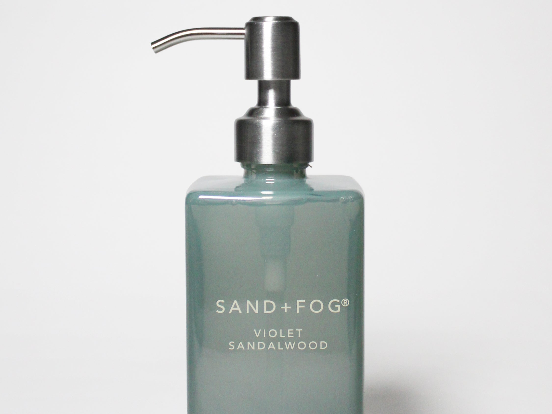 SAND+FOG liquid hand soap bottle with silver pump, teal glass and “Violet Sandalwood” label