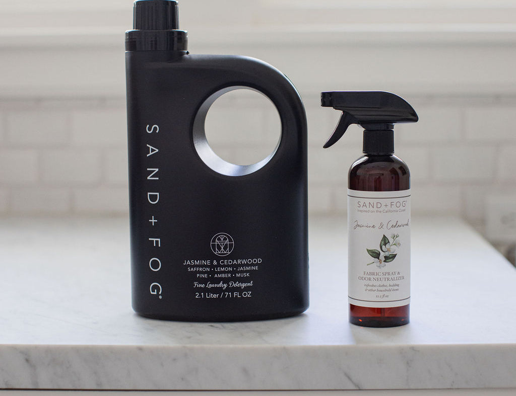 Black 71 oz laundry detergent jug with molded handle and matching scent bottle