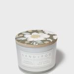 SAND+FOG scented candle with floral lid, natural wax blend label on jar