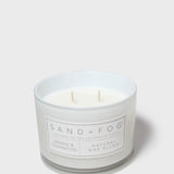 SAND+FOG scented candle in clear glass jar with two wicks, white label