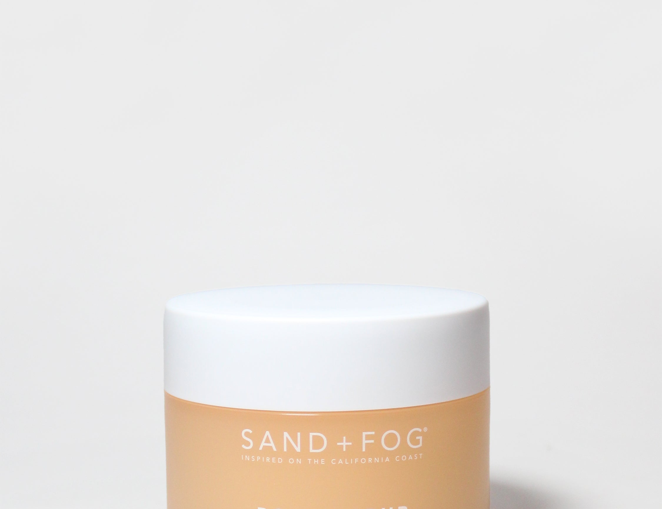 SAND+FOG body scrub jar, white lid, beige tub, Mango Gelato label