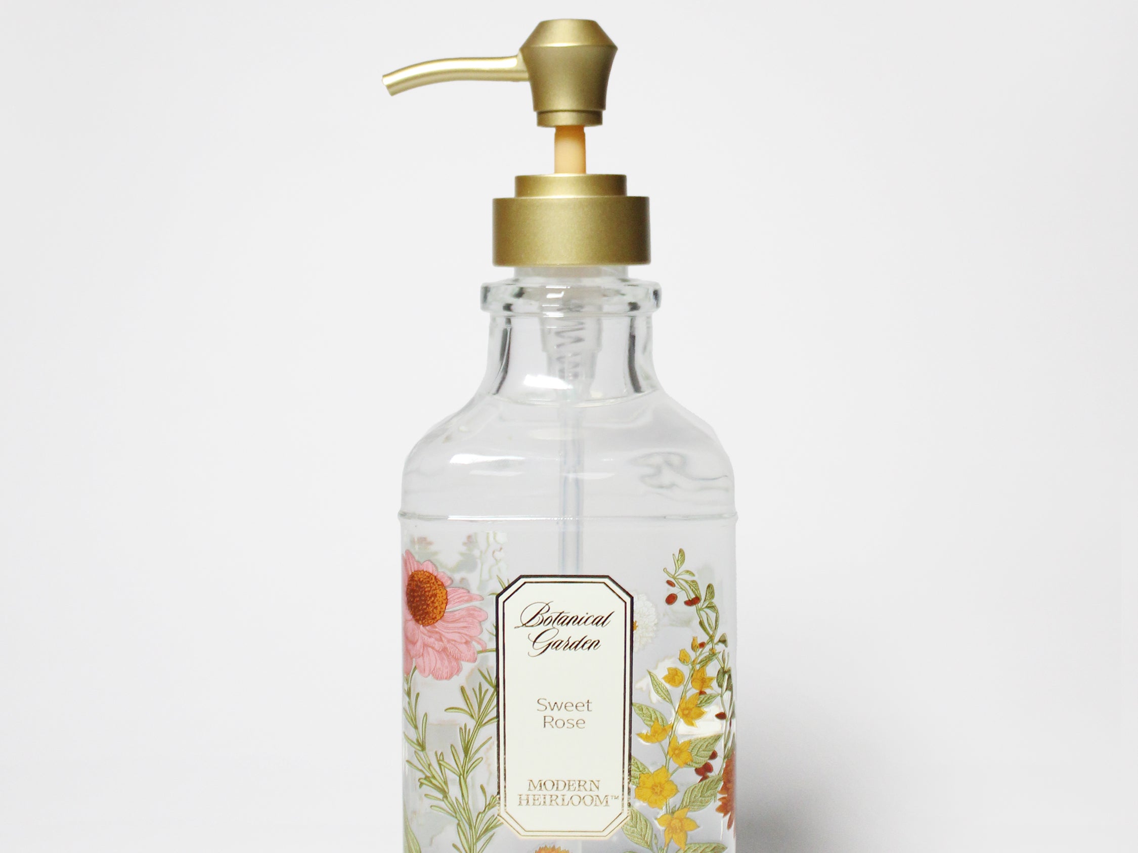 Liquid hand soap bottle with gold pump and floral Sweet Rose label