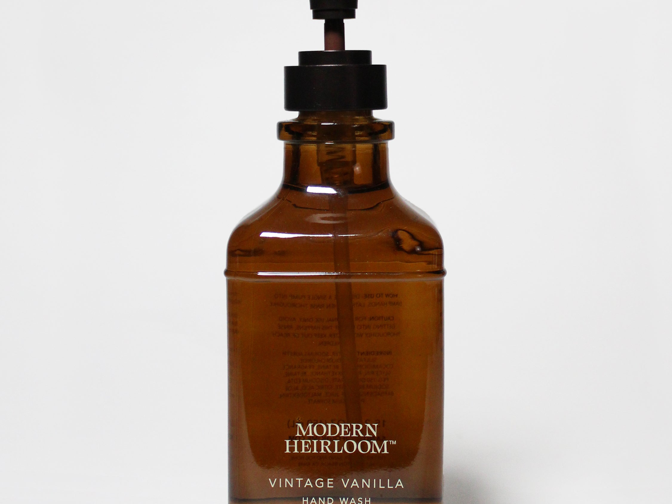 Amber glass liquid hand soap bottle with black pump, vintage vanilla label