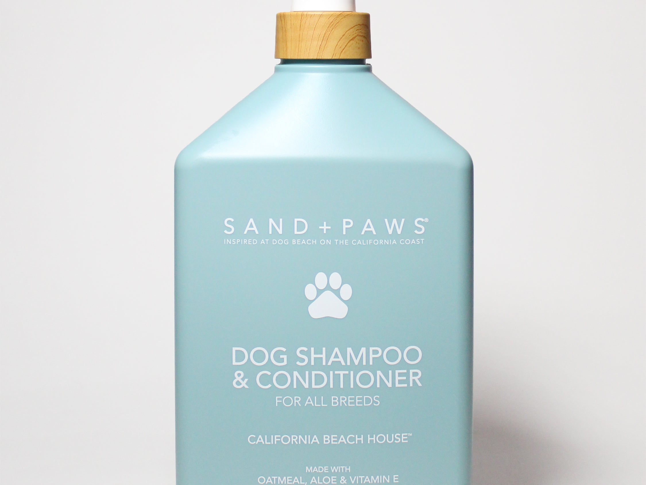 Light blue pet dog shampoo & conditioner bottle with pump, paw logo