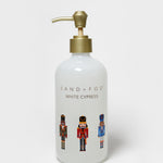 White Cypress liquid hand soap in a white pump bottle with a brass-colored dispenser and nutcracker graphics