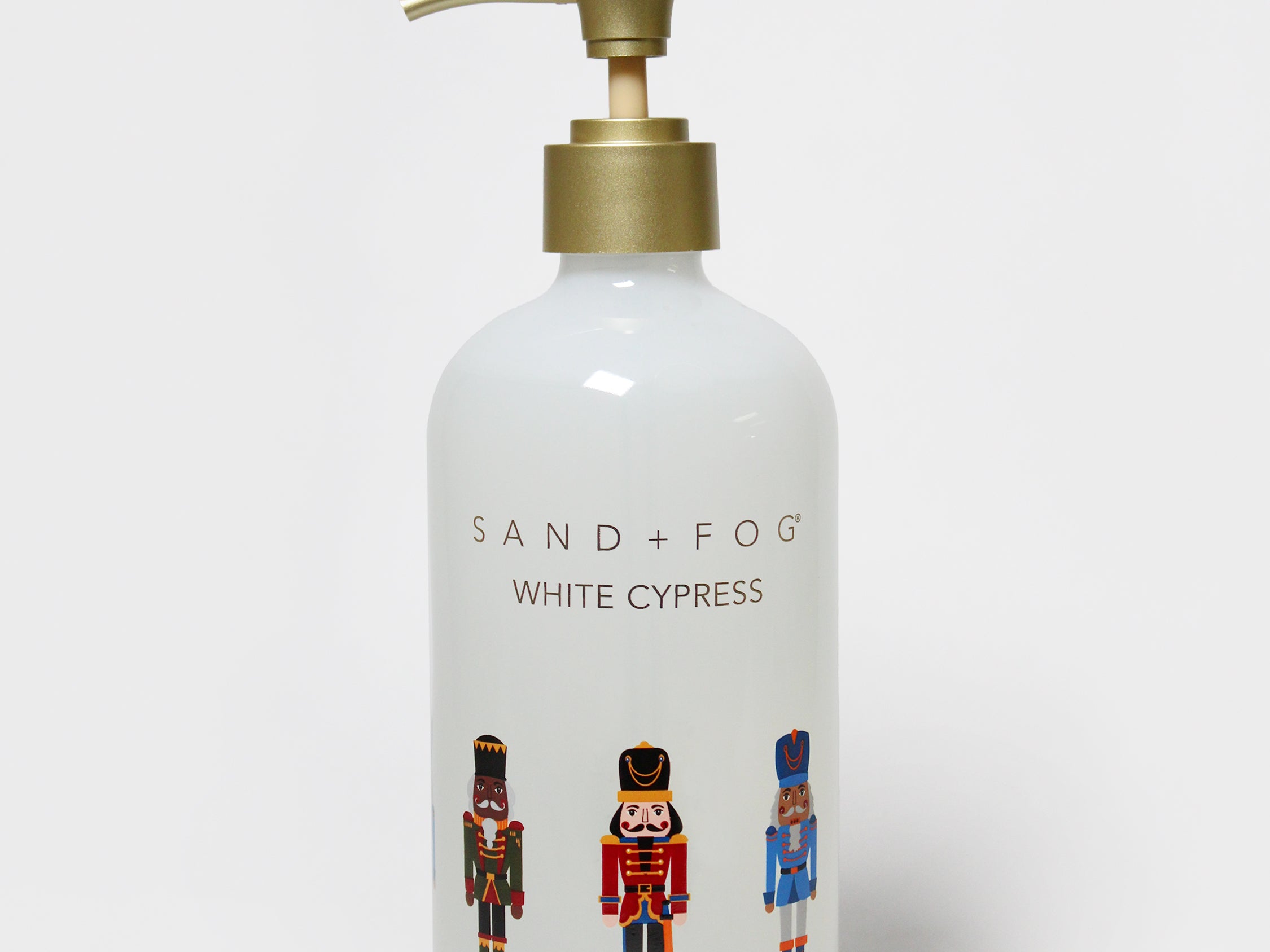 White Cypress liquid hand soap in a white pump bottle with a brass-colored dispenser and nutcracker graphics