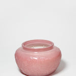 Cedarwood and rose scented candle in a pink embossed glass jar with two wicks.