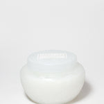 Marshmallow Suede scented candle in a rounded white glass jar with a fitted lid.