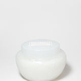 Marshmallow Suede scented candle in a rounded white glass jar with a fitted lid.