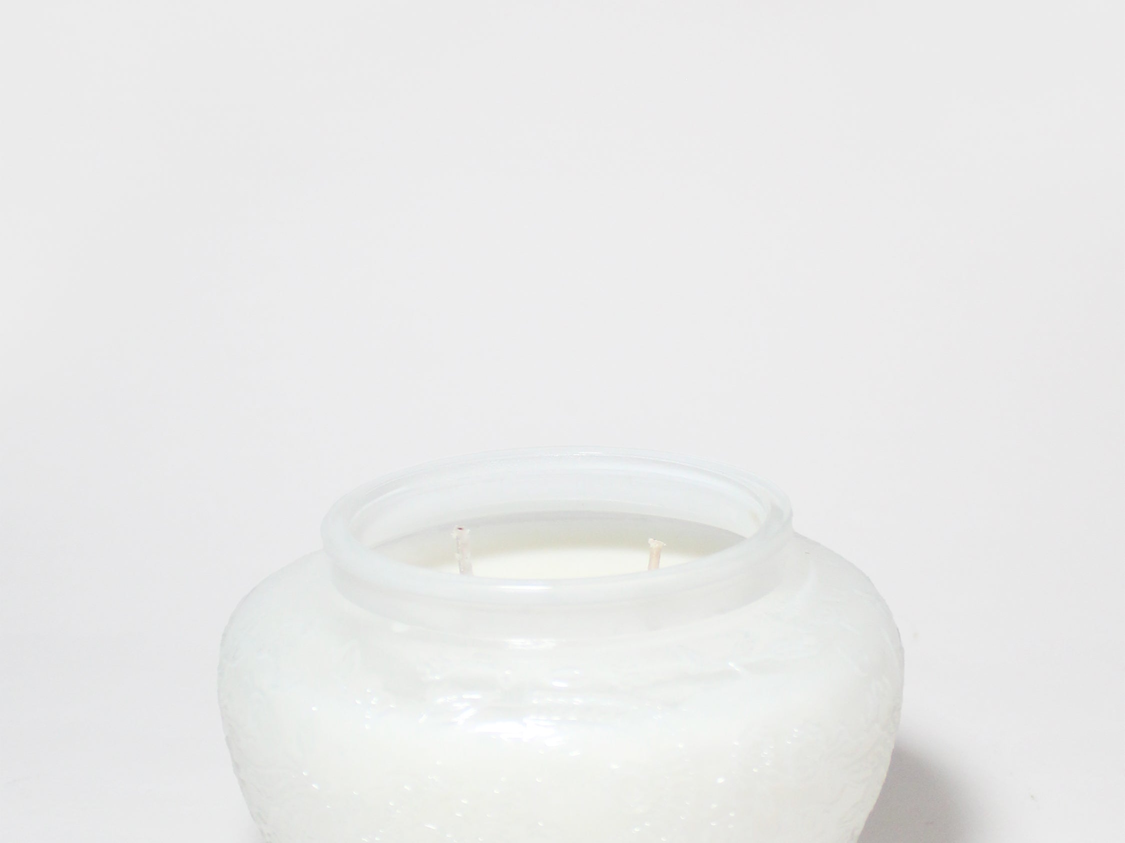 Marshmallow Suede 17 oz scented candle in a rounded white glass jar with two wicks.